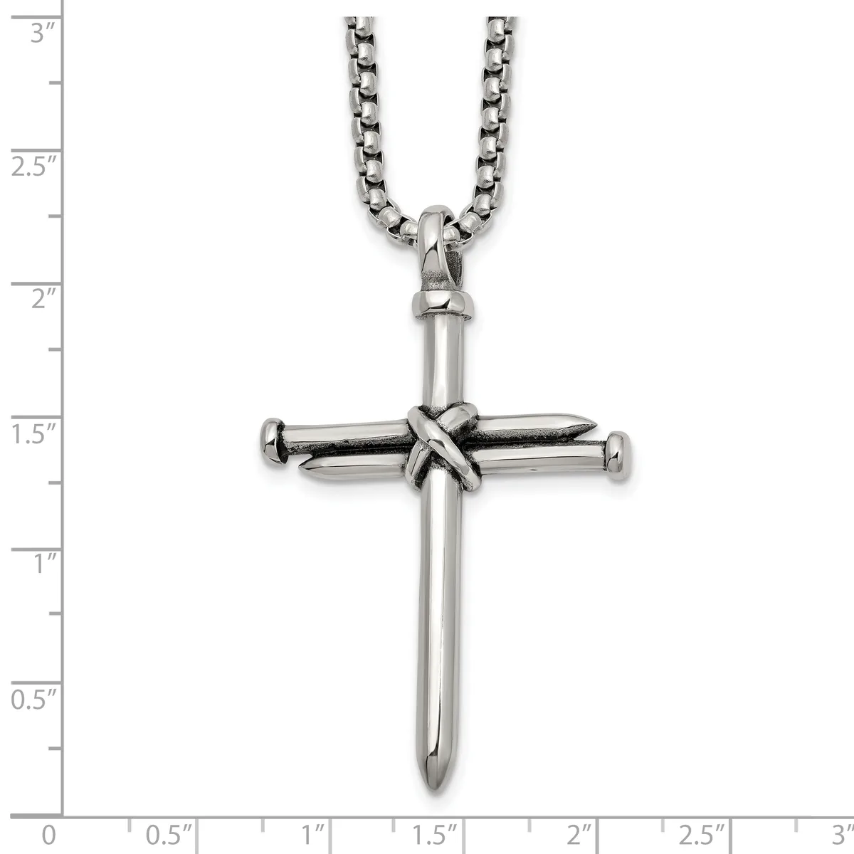 Stainless steel cross pendant with wrapped detail at center, hanging from a curb chain, shown against a measurement scale.