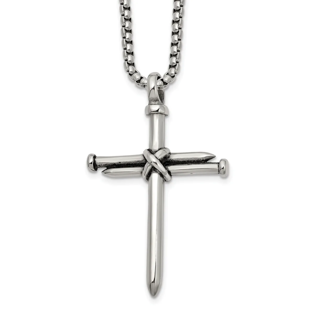 Silver-toned metal cross pendant with nail design at center, suspended from a rolo chain necklace against a white background.