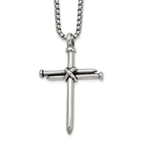 Silver-toned metal cross pendant with nail design at center, suspended from a rolo chain necklace against a white background.