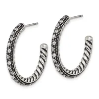 Pair of silver hoop earrings with twisted inner texture and crystal-studded outer surface, shown from the front.