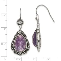 Pair of silver teardrop dangle earrings with faceted amethyst stones surrounded by beaded bezels and round diamond accents on shepherd hook wires, shown against a measurement scale.