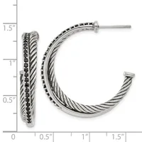 Silver twisted cable hoop earrings with black stone accents along the outer edge, shown with a measurement scale indicating approximately 1.5 inches in length.