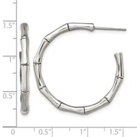Two polished silver-toned hoop earrings with segmented bamboo-style tubing, shown next to a ruler indicating approximately one and one-half inches in length.