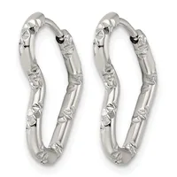A pair of silver textured hoop earrings with a hammered surface finish and rounded rectangular shape.