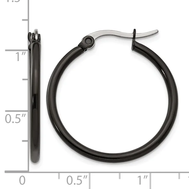 A pair of black hoop earrings with a polished finish and hinged closures, shown next to a ruler indicating they measure approximately one inch in diameter.