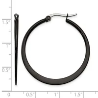 Black hoop earrings with stainless steel posts displayed next to a ruler showing the earrings measure approximately 1.5 inches in diameter.