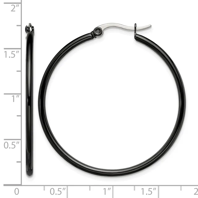 A pair of black hoop earrings with silver-toned posts and backs, displayed next to a ruler showing their approximately 1.5-inch diameter.