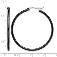 A pair of black hoop earrings with silver-toned posts and backs, displayed next to a ruler showing their approximately 1.5-inch diameter.