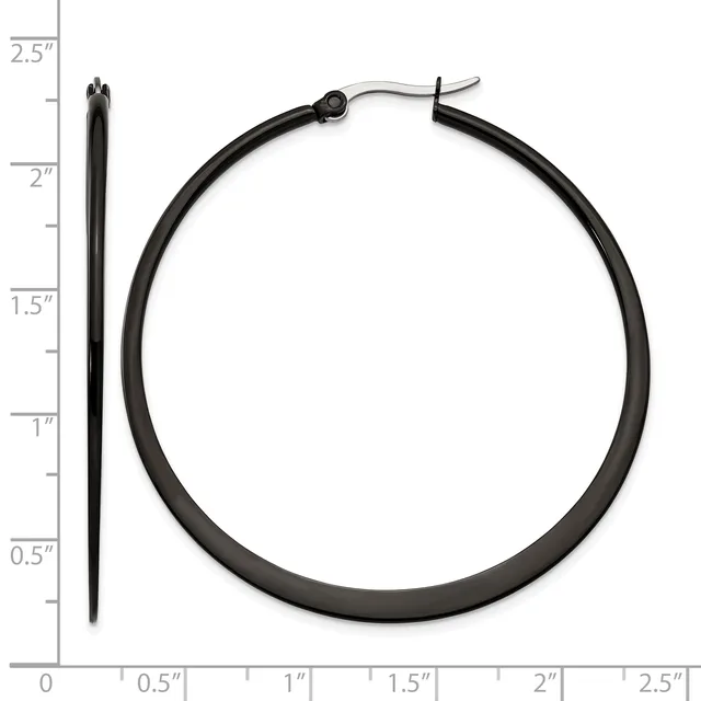 Black tubular hoop earrings displayed next to a ruler showing approximately 2.5 inches in diameter, with a hinged post closure visible at the top.