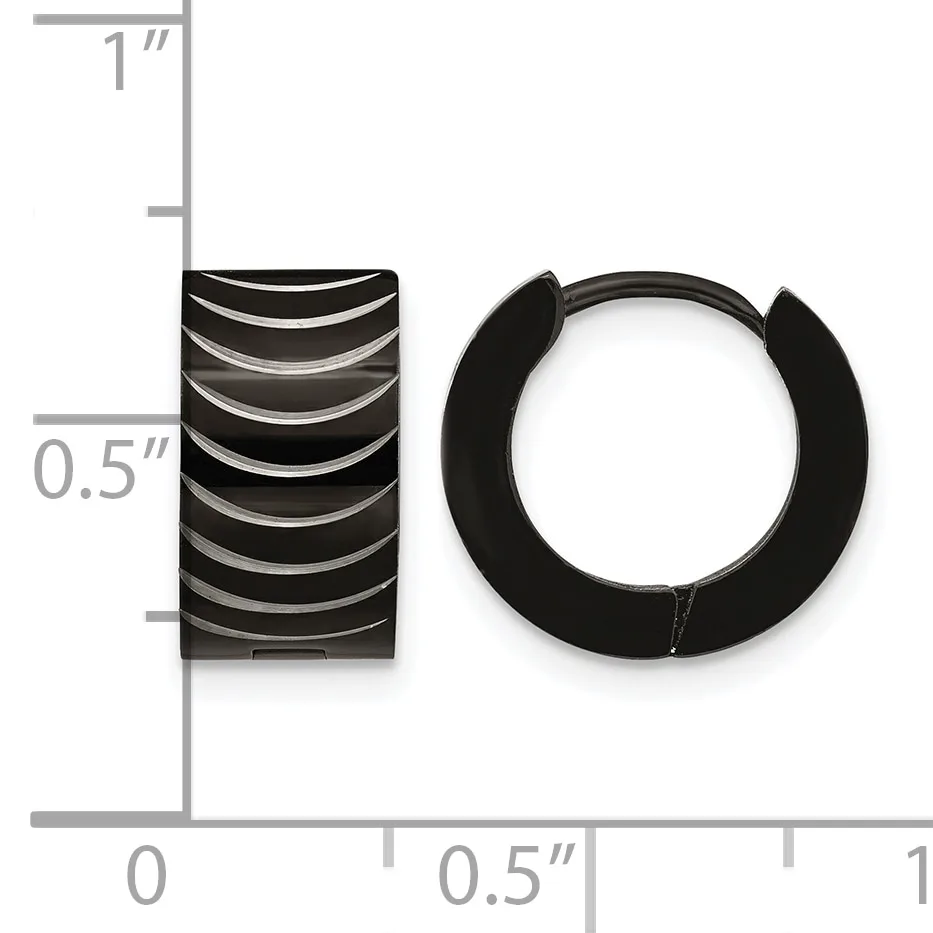 Black ridged barrel-shaped earring and black rubber huggie-style hoop earring displayed next to a ruler showing approximately 0.5 inch width and 1 inch height.