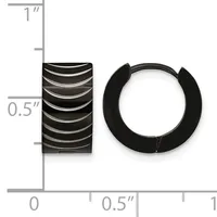 Black ridged barrel-shaped earring and black rubber huggie-style hoop earring displayed next to a ruler showing approximately 0.5 inch width and 1 inch height.