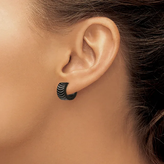 A black textured curved hoop earring worn in a pierced earlobe, shown from the side profile view.