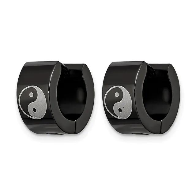 A pair of black polished stainless steel huggie earrings with yin-yang symbol inlays in silver tone on the outer surface.