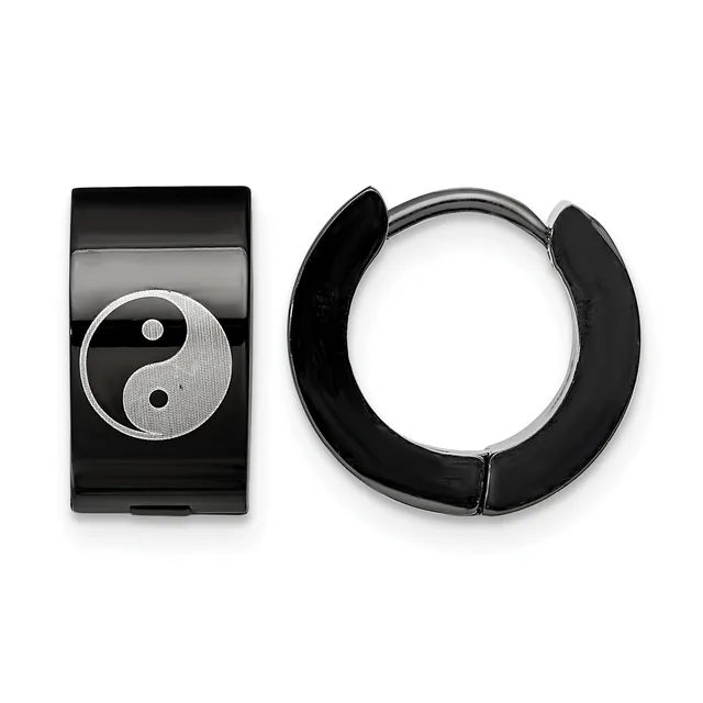 A pair of black and silver hoop earrings displayed next to a rectangular black pendant featuring a yin-yang symbol in silver and textured finish.
