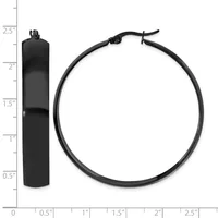 Two black metal objects displayed against a ruler: a cylindrical pendant with a loop top measuring approximately 2.5 inches tall, and a circular bracelet or bangle with an adjustable clasp.