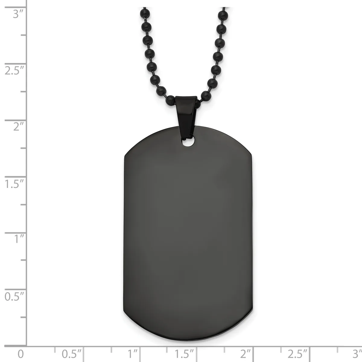 A black stainless steel dog tag pendant with rounded corners hangs from a black beaded chain, displayed against a measurement scale.