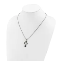 A silver-toned cross pendant hangs from a delicate chain on a white mannequin bust display.