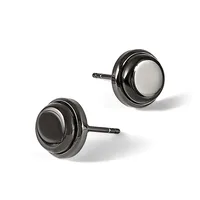 Two round stud earrings with polished gunmetal gray finish and white stone centers, displayed at angles on white background.