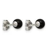 A pair of silver stud earrings with black onyx spheres and decorative butterfly-shaped backs, shown from the front and back.