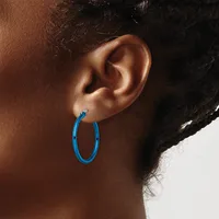 A person wearing a blue hoop earring is shown in profile, displaying the earring against their ear and neck.