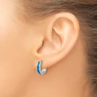A person wearing a small hoop earring with a blue stripe detail on the outer curved surface, shown from a side profile view.