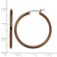 A pair of bronze-toned hoop earrings with hinged posts, shown next to a ruler indicating they measure approximately 1.5 inches in diameter.