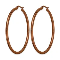 A pair of large copper-toned hoop earrings with a polished finish and hinged closures, displayed against a white background.