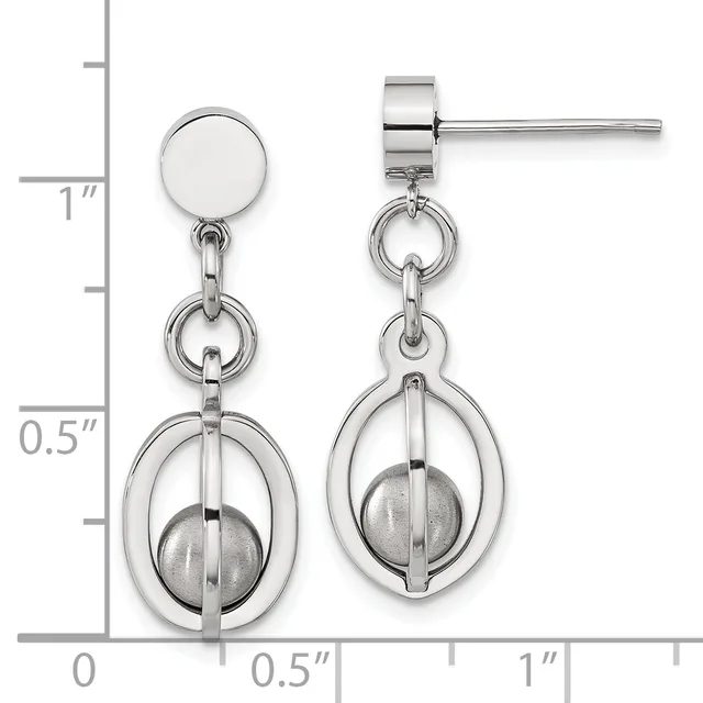 Pair of silver-tone stud earrings with circular tops and dangling oval frames enclosing spheres, displayed against a measurement scale.