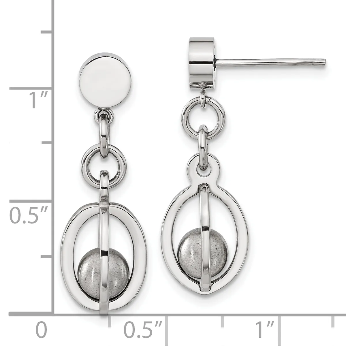 Pair of silver-tone stud earrings with circular tops and dangling oval frames enclosing spheres, displayed against a measurement scale.