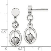 Pair of silver-tone stud earrings with circular tops and dangling oval frames enclosing spheres, displayed against a measurement scale.