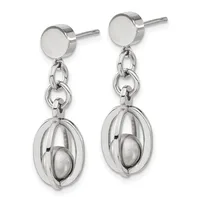 A pair of silver dangle earrings with flat circular posts connected by chain links to oval cage pendants containing movable spheres inside.