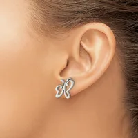 A silver butterfly-shaped stud earring worn on a person's earlobe, shown in profile against their neck and shoulder.