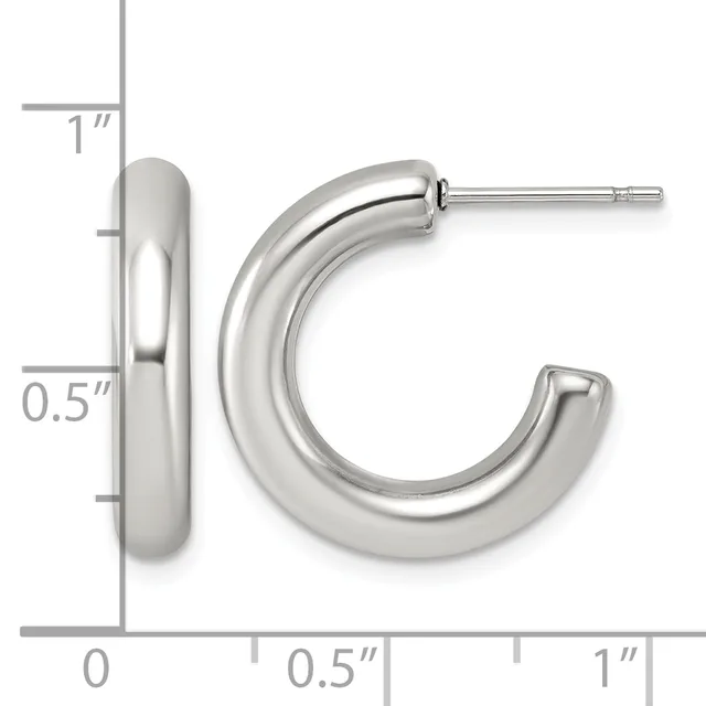 A pair of polished silver-toned chunky hoop earrings with posts and backs, shown next to a measurement scale indicating approximately one inch in height and half inch in width.