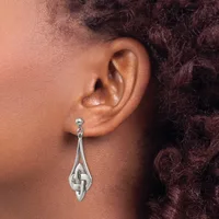 A silver teardrop-shaped dangle earring with a Celtic knot design, shown worn on a person's earlobe.