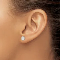 A person wearing a small oval diamond stud earring in their pierced earlobe, shown in profile view.