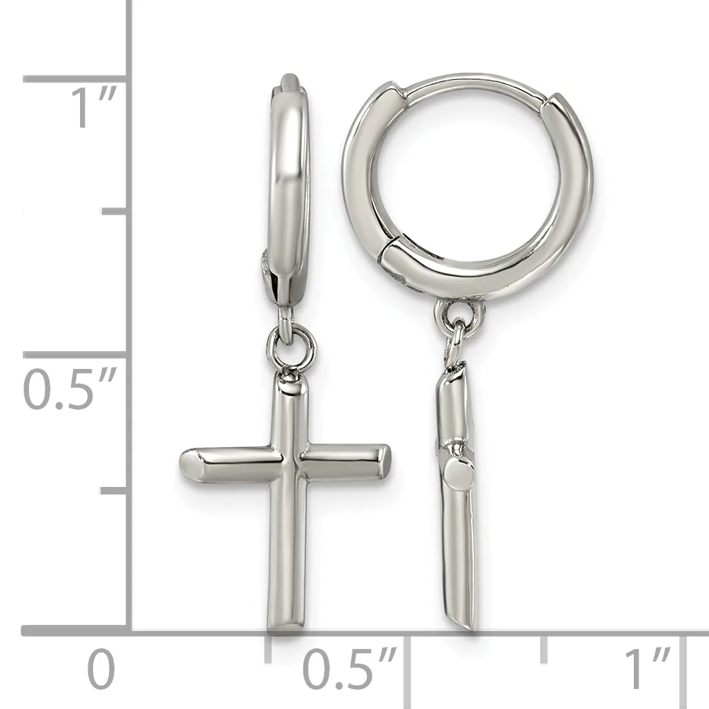 Pair of polished silver-tone huggie hoop earrings, one with a dangling cross charm, displayed against a ruler showing measurements up to one inch.