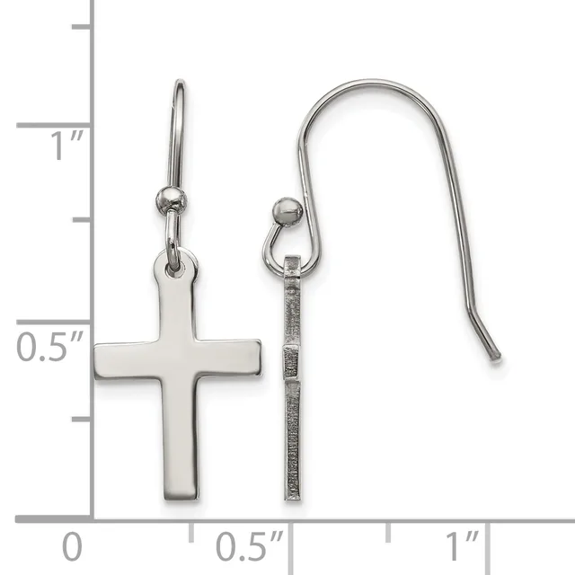 Two silver earrings displayed against a ruler showing measurements up to one inch: a plain cross pendant on a short earring post, and a textured cylindrical bar on a curved hook earring.