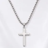 A silver cross pendant hangs from a silver box chain necklace against a white background.