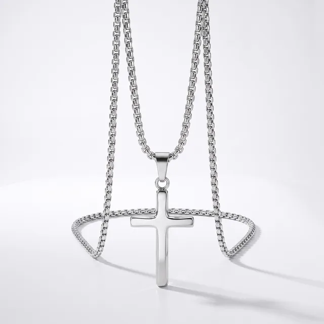 Silver-toned chain necklace with a polished cross pendant and matching decorative chain bracelet displayed on a white background.