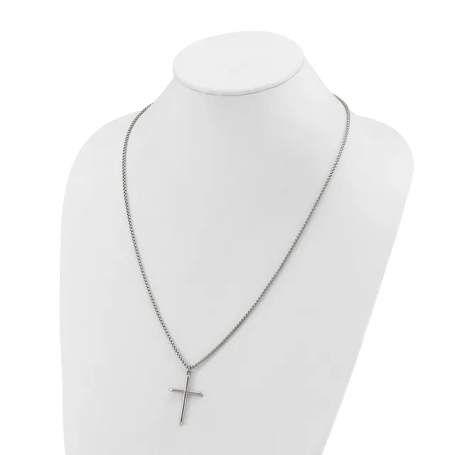 A silver-toned chain necklace with a simple cross pendant displayed on a white mannequin bust.