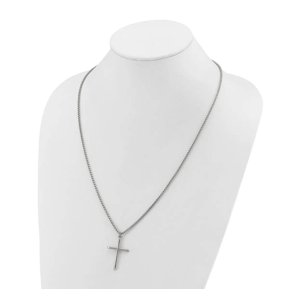 A silver-toned chain necklace with a simple cross pendant displayed on a white mannequin bust.