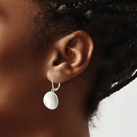 A person wearing silver hoop earrings with white disc pendants hanging from their earlobes, shown in profile against a white background.
