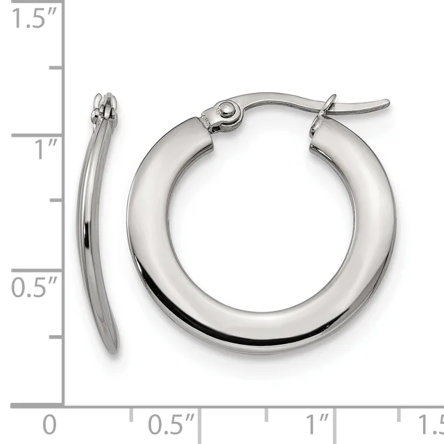 A pair of polished silver-toned hoop earrings with a chunky, rounded profile and clip-back closures, displayed against a ruler showing approximately 1 inch in diameter.