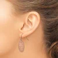 A person wearing a textured oval pendant earring on a curved ear wire, shown from the side view against their neck and shoulder.