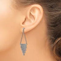 A woman wearing a long chandelier earring with a triangular top and cascading rectangular rhinestone strands hanging from her earlobe.