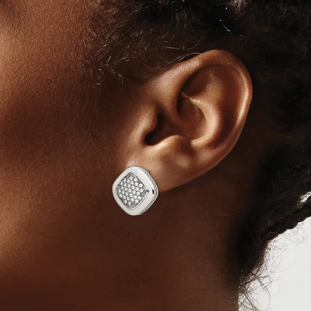 A white metal square stud earring with pave-set small round stones displayed on a person's earlobe.