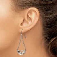 A woman wearing silver threader earrings with semicircular pendant drops hangs them from her ears against her bare shoulder.