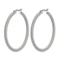Pair of large oval hoop earrings with a textured diamond-cut surface finish in silver-toned metal, shown against a white background.