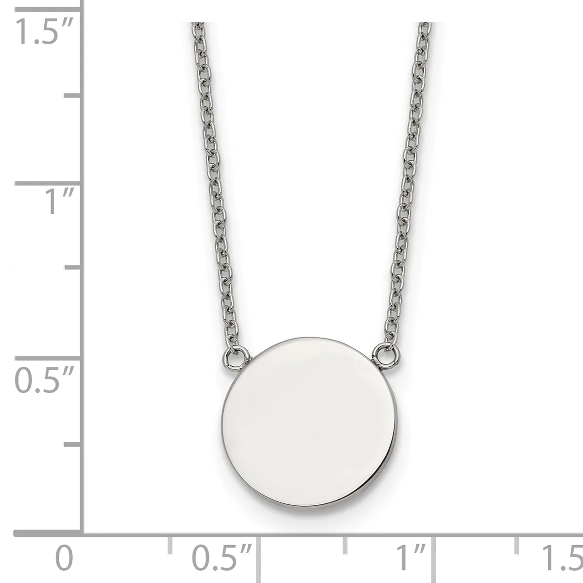 A silver circular pendant hangs from two thin chain strands, shown next to a ruler measuring approximately 1.5 inches in total length.