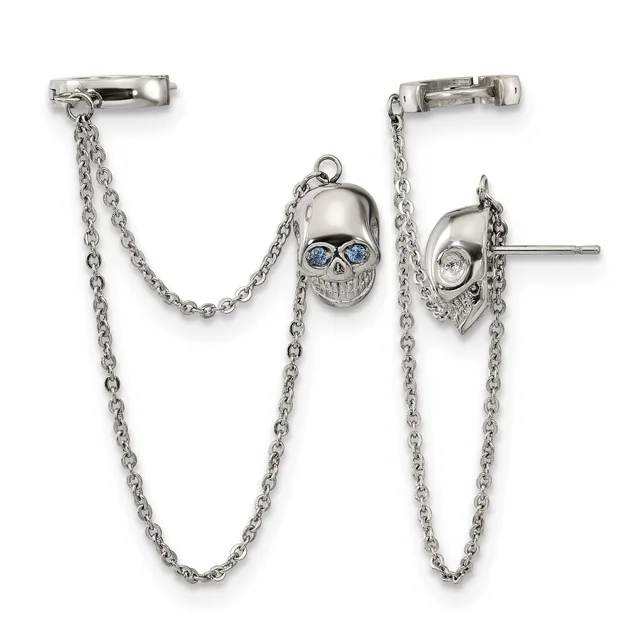 A pair of silver skull ear cuffs with blue crystal eyes connected by delicate chains, displayed against a white background.